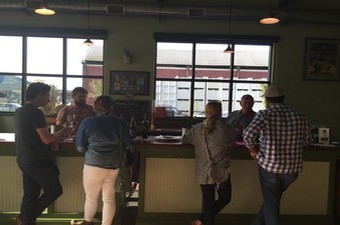 Visitors at the tasting room bar enjoy chatting and tasting wines with Jamie and Fred Peterson